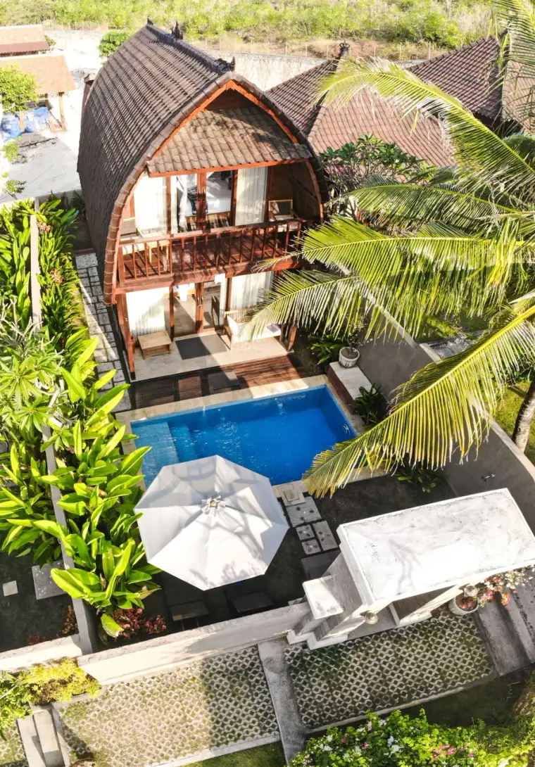 Wooden villa with a private pool among tropical trees
